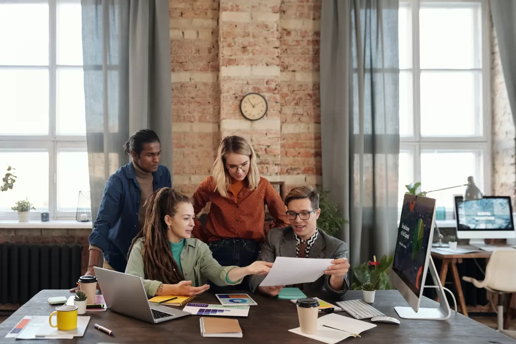 4 personas reunidas en un escritrio charlando y debatiendo sobre estrategias para definir buyer persona